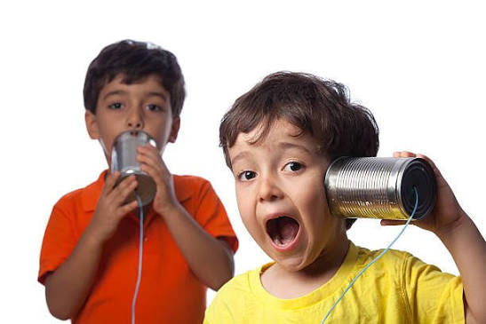 tin can telephone used by two young children